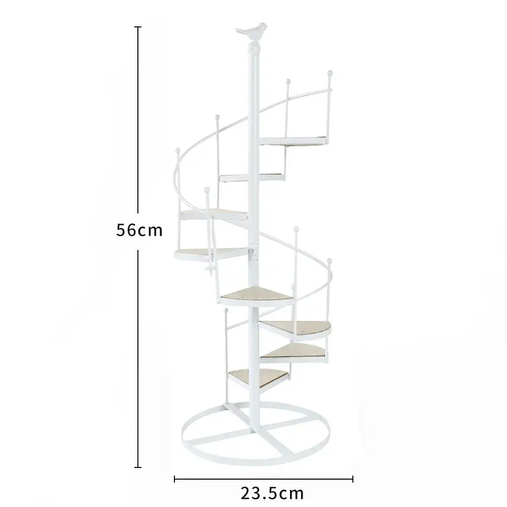 White spiral stair shape iron plant stand with beige cushioned steps wood plate and bird finial top by DecorBites