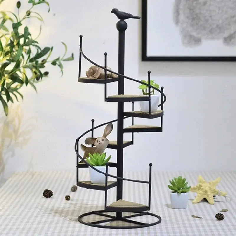 Black metal spiral stair shape plant stand with wood plate tiers and decorative bird perched atop by DecorBites™