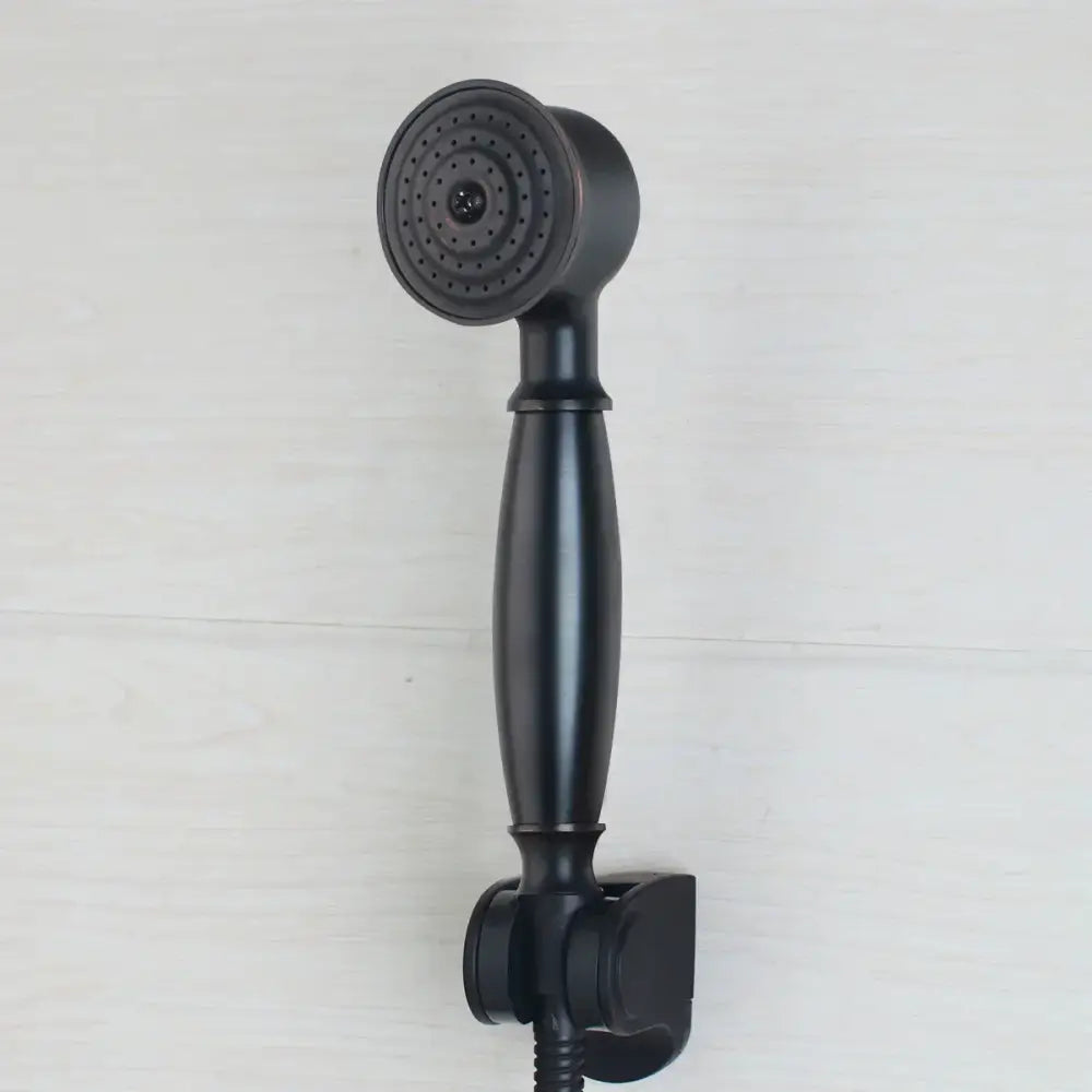 Black matte handheld showerhead with circular spray face and ergonomic handle in DecorBites™ shower faucet set