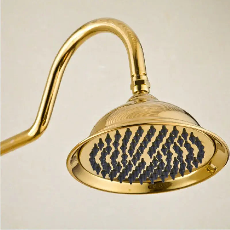 Gold-colored ornate DecorBites™ 8 inch rainfall shower tub faucet set with curved arm and diamond-patterned blue nozzles