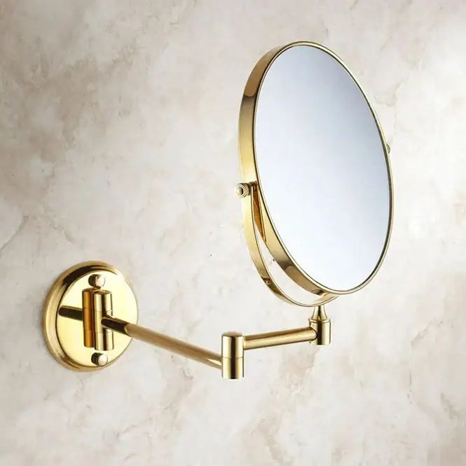 Gold-finished brass dual makeup mirror with 8 inch round glass and sleek articulated arm for wall mounting