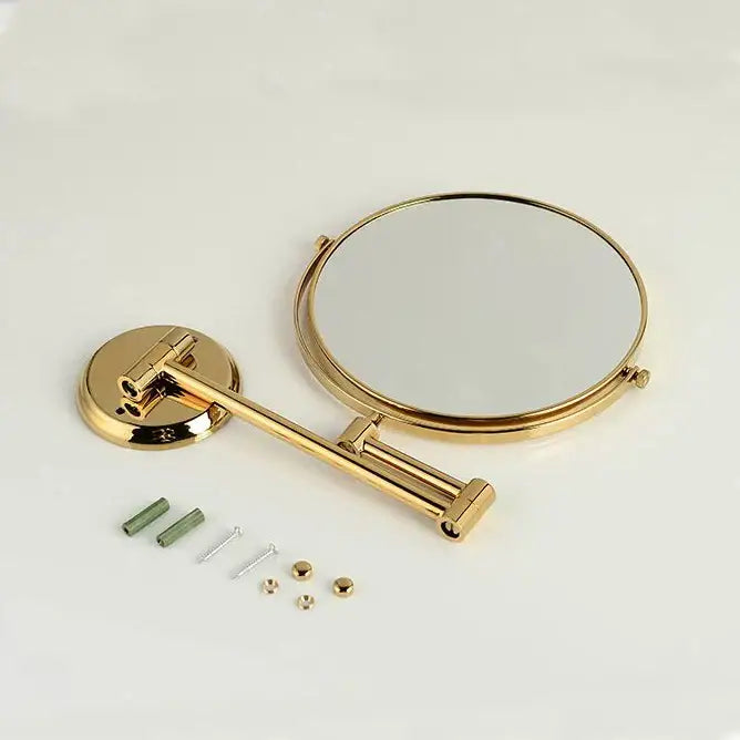 Gold-finished dual makeup mirror with 8 inch round brass frame, 3X magnification, and adjustable articulated arm wall mount
