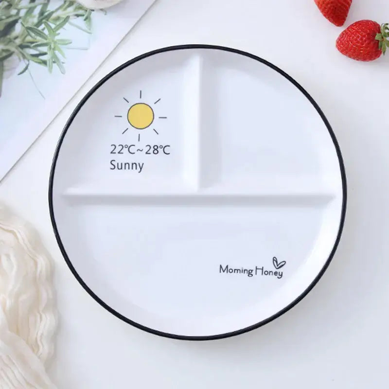 White ceramic DecorBites™ 8 inch round grid plate with black rim and sun graphic for solo dining or family breakfast
