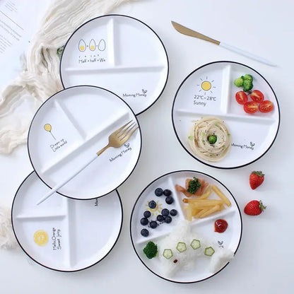 White ceramic round grid plate with black rims and cute food-themed illustrations perfect for solo dining