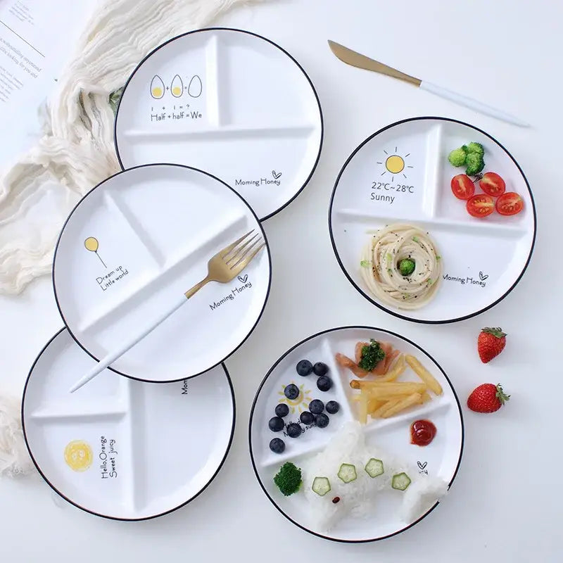 White ceramic round grid plate with black rims and cute food-themed illustrations perfect for solo dining