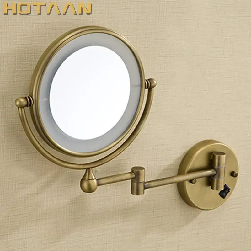 Antique brass round led light makeup mirror with dual 3x/1x magnification and adjustable wall-mounted arm by DecorBites