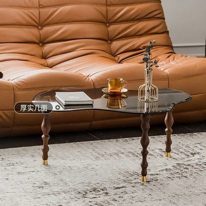 Decorbites™ solid wood peanut-shaped coffee table with sleek black glass top and gold-toned feet for living room