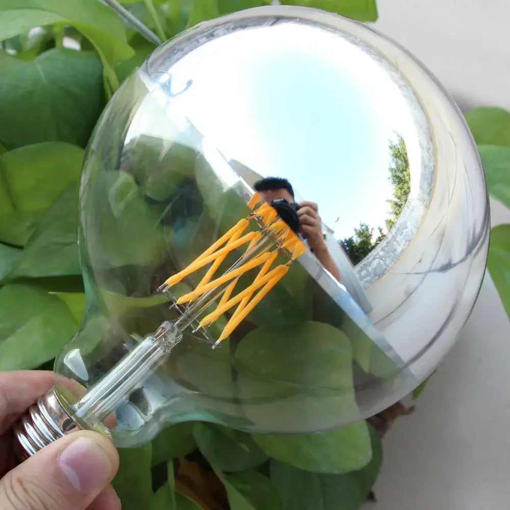 Clear glass decorbites™ filament dimmable g45 bulb with silver screw base and intricate yellow led filament inside