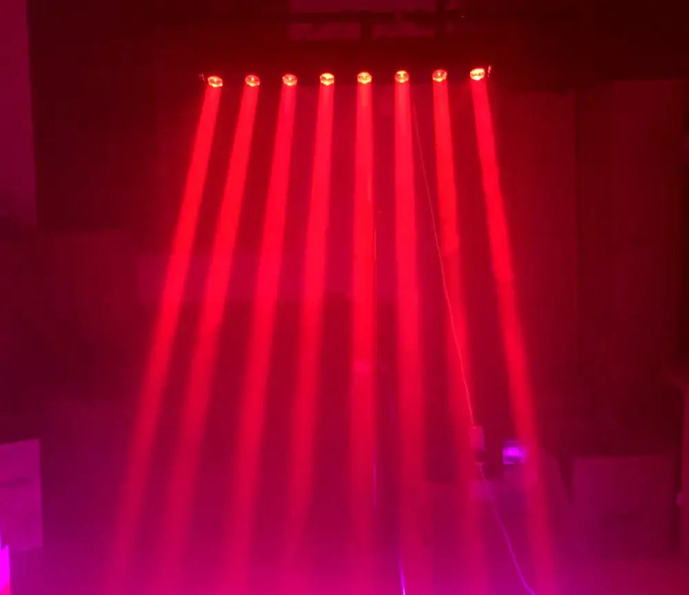 A set of six red DecorBites™ 8x15w rgbw moving head led beam lights shining vibrant beams in a darkened space