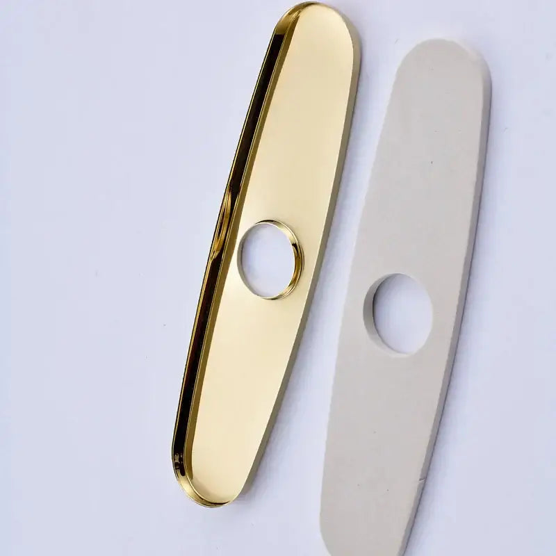 DecorBites™ gold-finished kitchen sink faucet hole cover plate with a central hole and smooth elongated oval shape