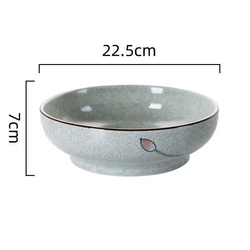 A light gray speckled ceramic ramen noodle bowl with pink lotus design and dark rim measuring 22.5cm diameter