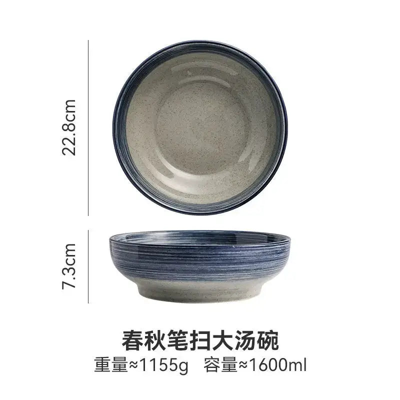 A retro ceramic ramen noodle bowl with speckled gray interior exterior and dark blue rim for Japanese style soup