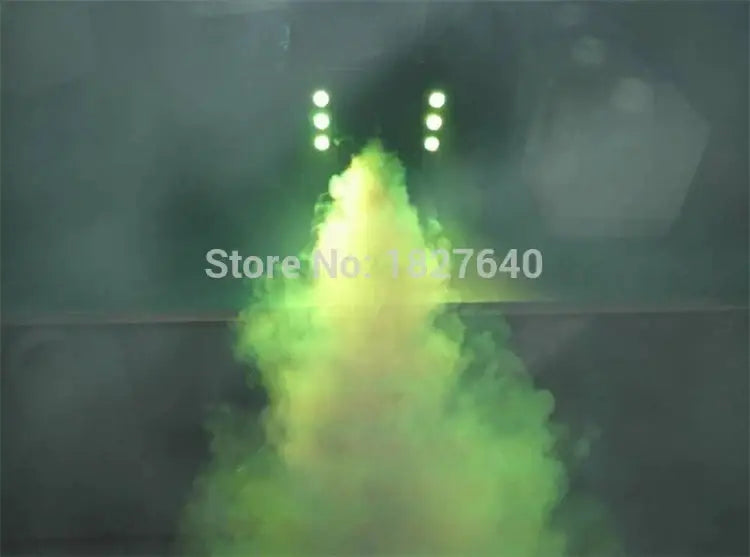 Green and yellow smoke billows from the decorbites™ 900w fog machine on stage, ideal for weddings and parties