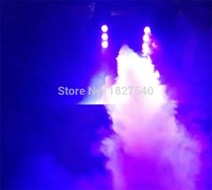 Decorbites 900w rgb wireless fog machine emitting vibrant purple and blue swirling smoke under bright spotlights