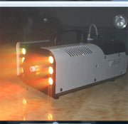 Decorbites 900w rgb wireless fog machine in silver and black with glowing orange lights for party and wedding use