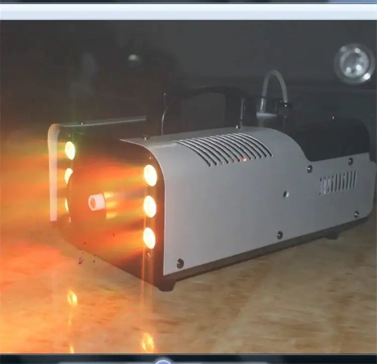 Decorbites 900w rgb wireless fog machine in silver and black with glowing orange lights for party and wedding use