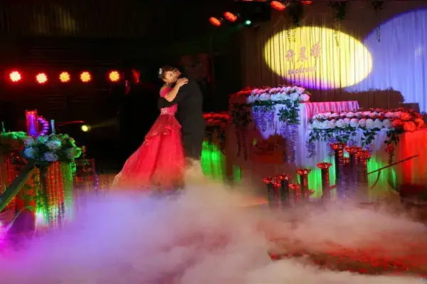 A vibrant red gown with intricate detailing shown alongside the decorbites wireless remote control smoke machine for stage use