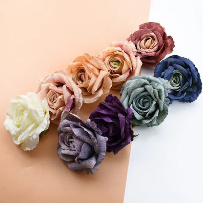 A collection of decorbites™ 9cm silk roses artificial flowers in cream peach dusty rose deep purple sage and navy blue tones