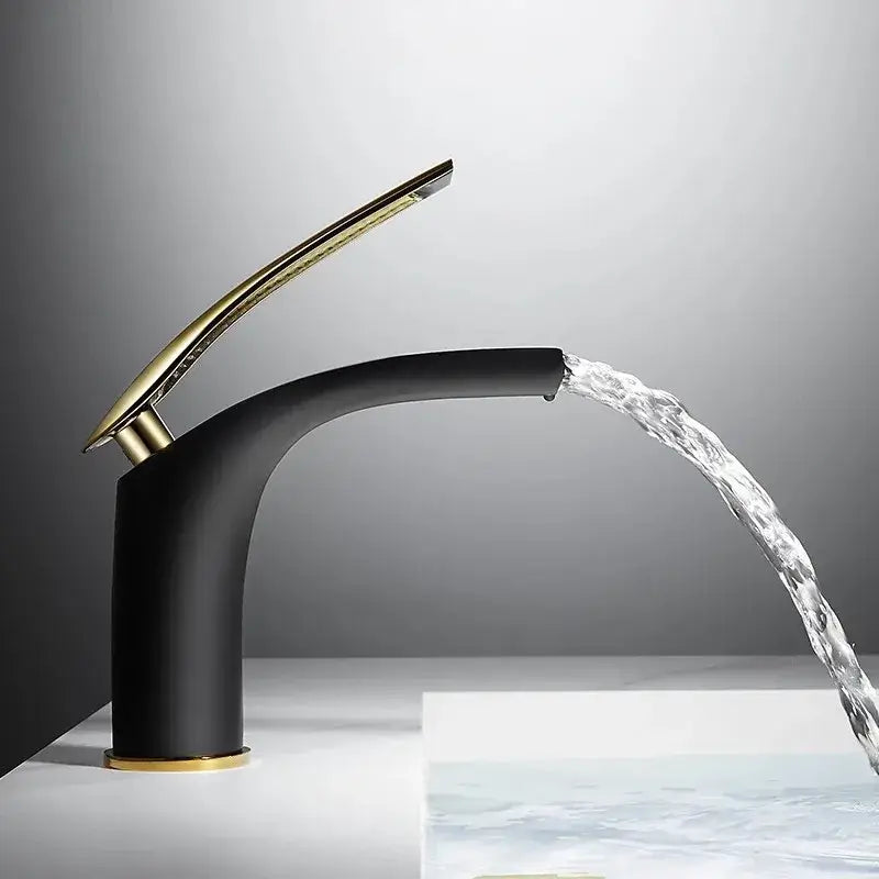 Modern black and gold faucet with a sleek curved design complementing the decorbites™ stainless steel gold dustbin