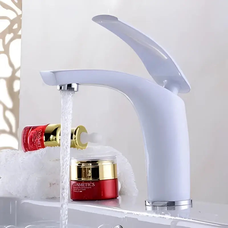 White ceramic faucet with sleek modern design and chrome accents paired with stainless steel gold dustbin by decorbites