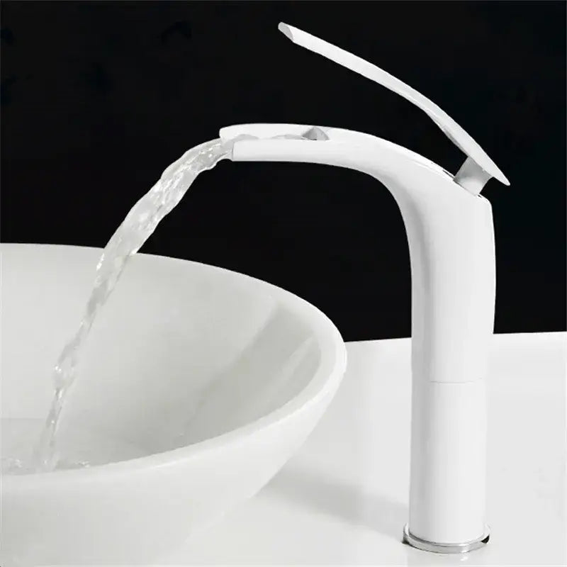 White modern waterfall faucet with sleek curved design and chrome accents complementing stainless steel gold dustbin