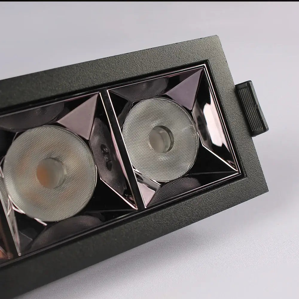 Black rectangular DecorBites recessed spot light with two textured lenses in a geometric frame for living room use