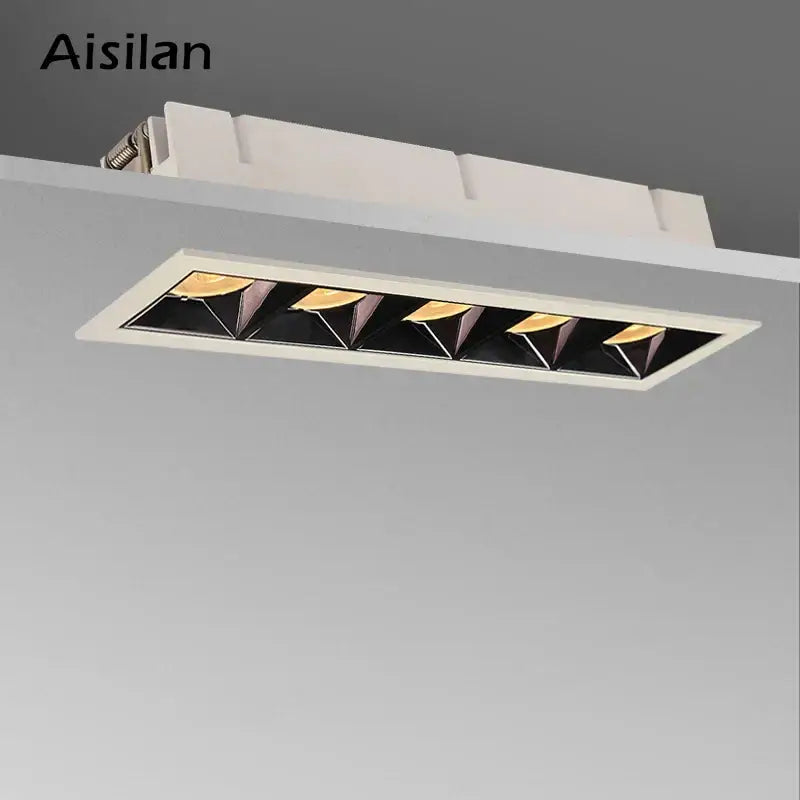 Aisilan decorbites recessed spot light with white frame and five black triangular reflectors housing warm gold led bulbs