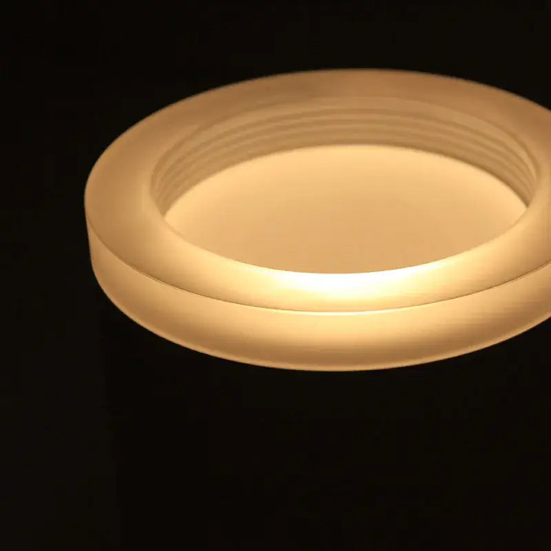 A sleek frosted glass candle holder with warm glow illustrating decorbites 9w cri97 anti-glare led downlight features