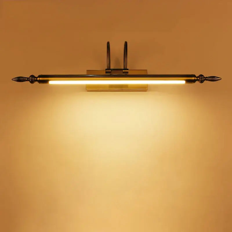 Brass-finished decorbites 9w led wall-mounted vanity light with spear-tipped ends and warm glowing illumination