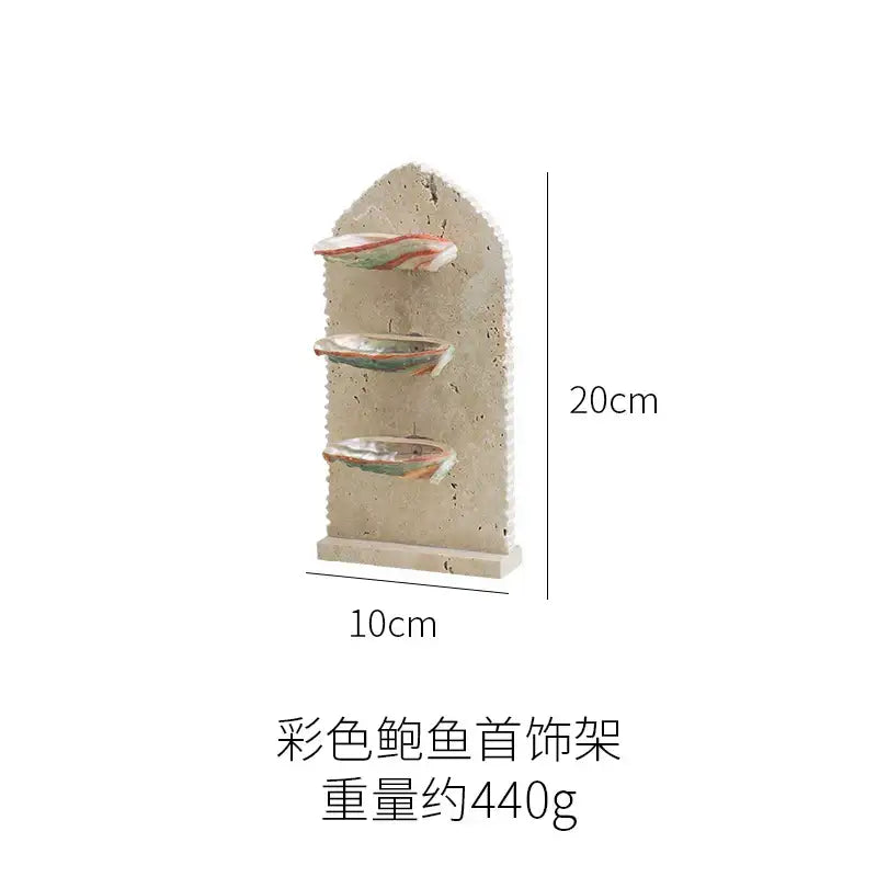 Beige ceramic decorbites abalone shell jewelry organizer with three tiered shelves holding colorful shell ornaments