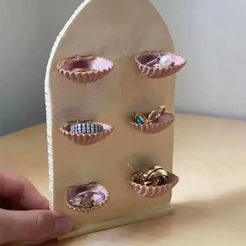 Beige arched decorbites abalone shell jewelry organizer with six pink scalloped dish holders for rings and earrings
