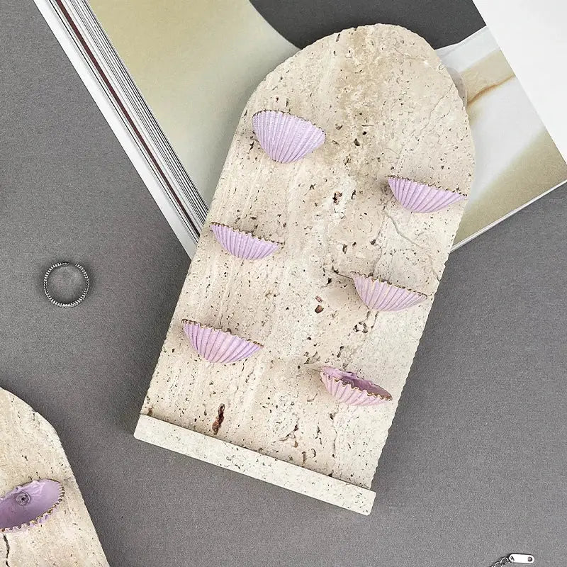 Beige stone decorbites abalone shell jewelry organizer with six lavender seashells arranged in a curved pattern