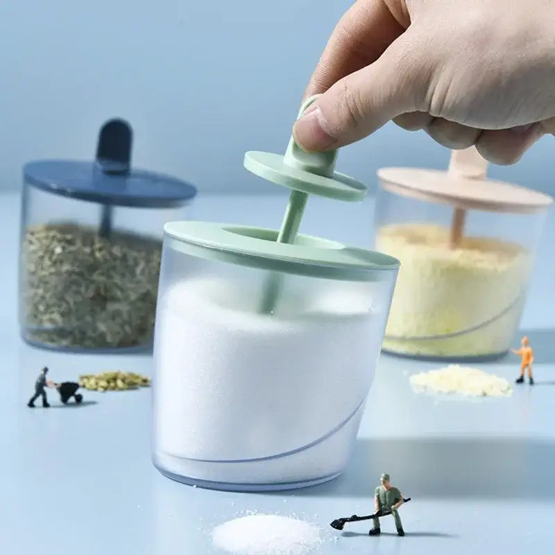 Clear decorbites abs spice jar with light green lid and handle filled with white sugar from spice jar set