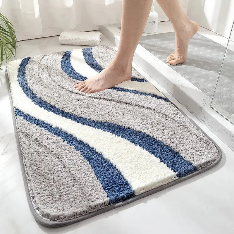 A decorbites absorbent water bathroom mat with soft, quick-drying wavy stripes in gray, navy blue, and white