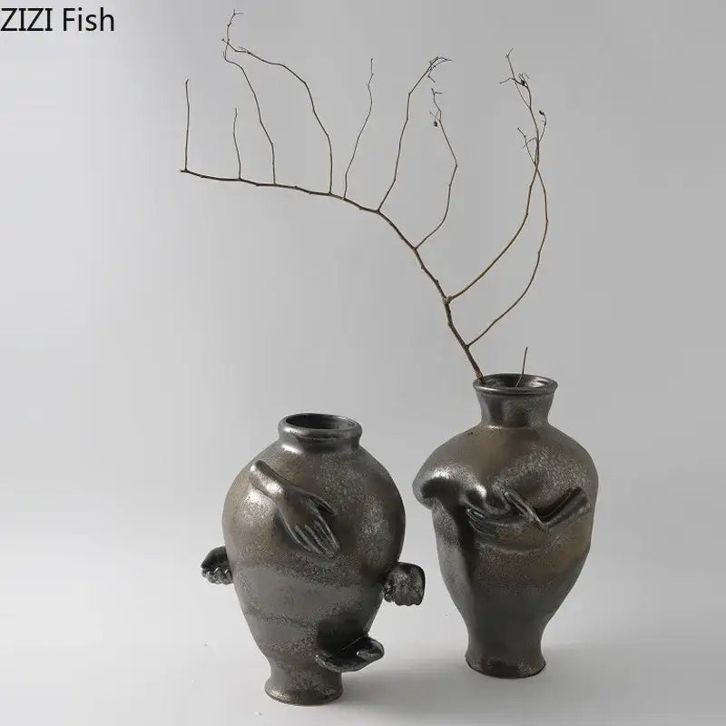 Two dark metallic ceramic vases with hand-like sculpted appendages from decorbites abstract art ceramic vase collection