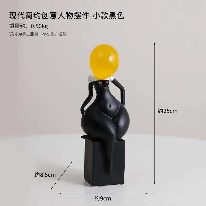 Black glossy resin abstract art female body figurine with yellow spherical head by DecorBites for home decor