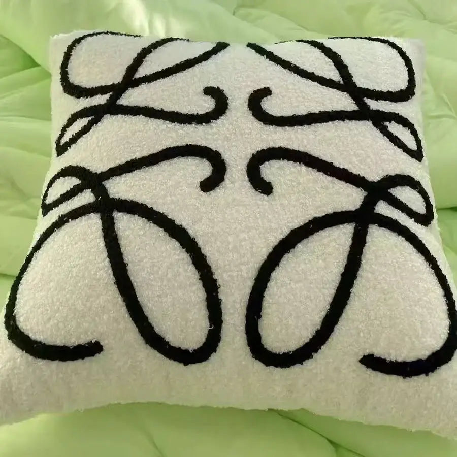 White textured cushion cover with bold black embroidered decorbites abstract art line logo plush pillowcase