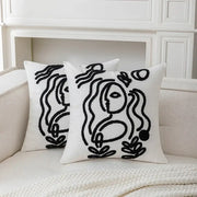 White plush cushion cover with black embroidered abstract art line designs by decorbites featuring stylized faces