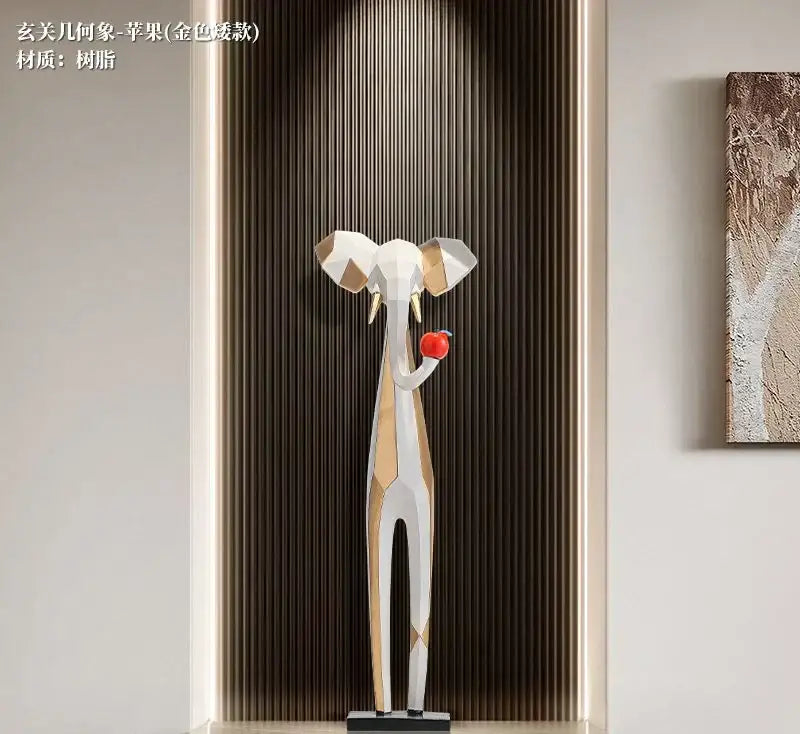 Decorbites abstract art living room tv cabinet featuring a tall white and gold geometric elephant sculpture holding a red apple