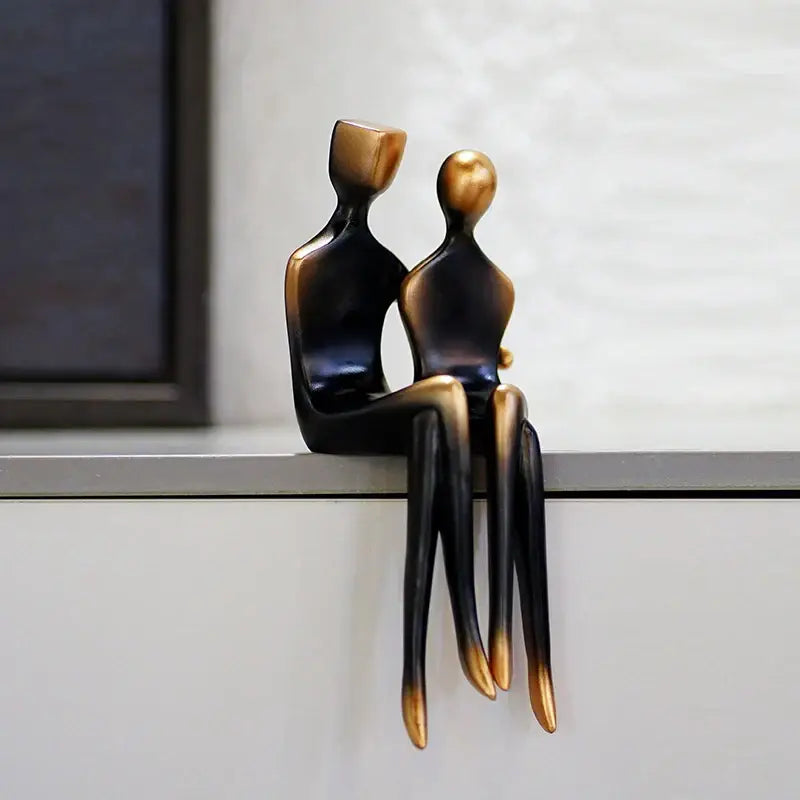 Abstract art lover resin statue decoration by decorbites featuring bronze and black stylized seated figures