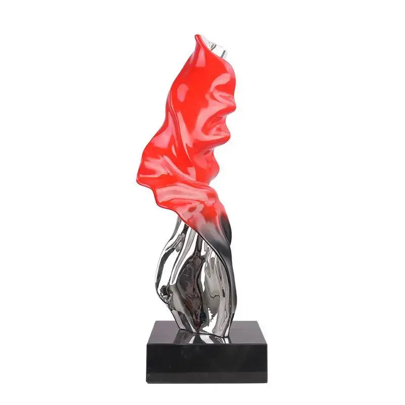 Vibrant red and chrome decorbites abstract art ribbon sculpture with flowing form on black base for large living room decor