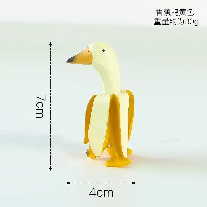 DecorBites™ abstract banana duck decorative figurine with glossy plastic finish in creamy yellow and vibrant orange accents