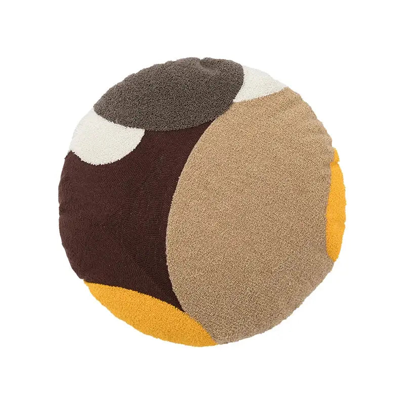 Round plush cushion cover with bold geometric patches in brown beige mustard yellow cream decorbites abstract beige coffee brown