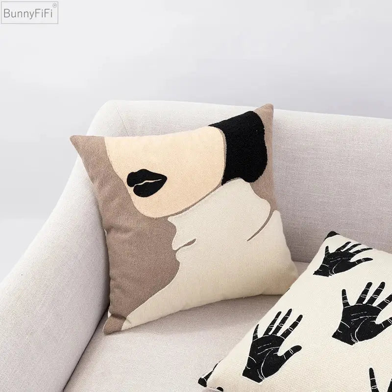 Beige and black embroidered cushion cover with stylized face design crafted from textured linen by DecorBites abstract beige coffee