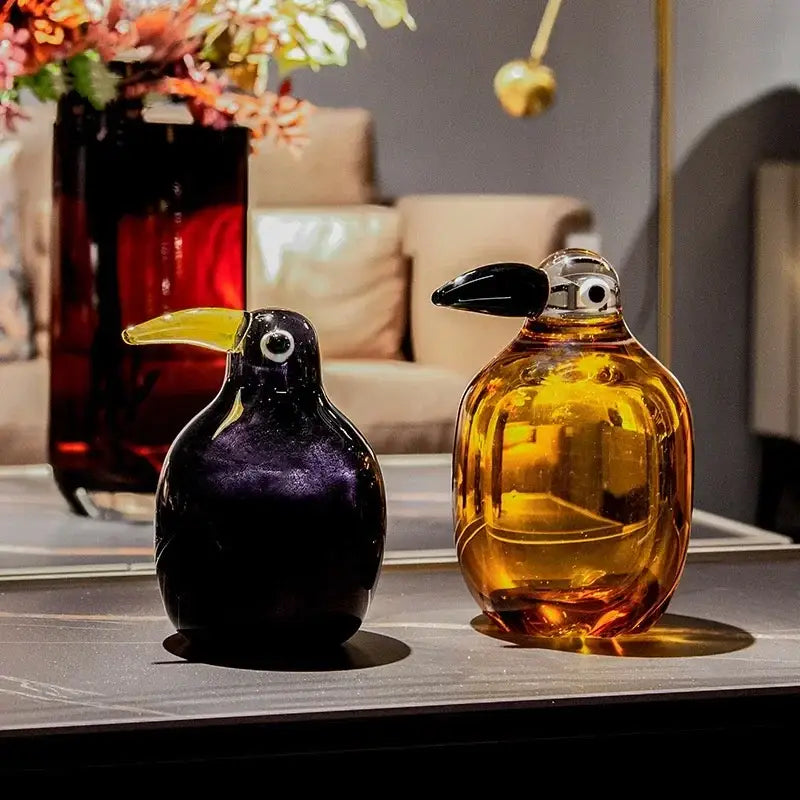 Two hand-blown glass toucan figurines in deep purple and amber with glossy finishes decorbites abstract bird sculpture home decor