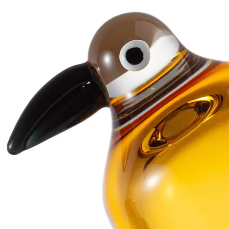 A glossy amber glass decorbites abstract bird sculpture with black beak and white eye ring for home decor