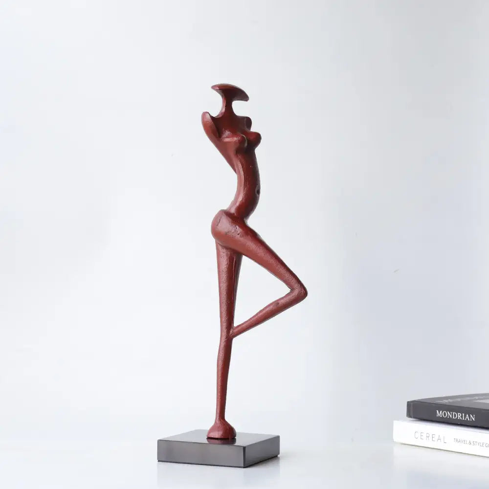 Decorbites abstract black metal female figure sculpture in red with raised arms on a dark gray rectangular base