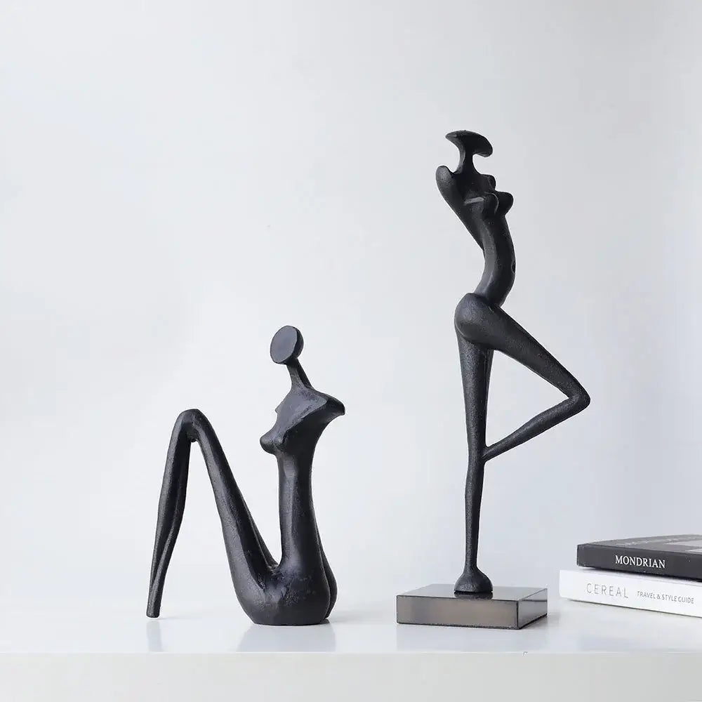 Decorbites abstract black metal female figure sculpture of standing woman with raised leg for home decor accessory