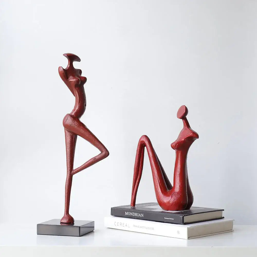 Decorbites abstract black metal female figure sculpture with two red resin stylized human figures standing and seated