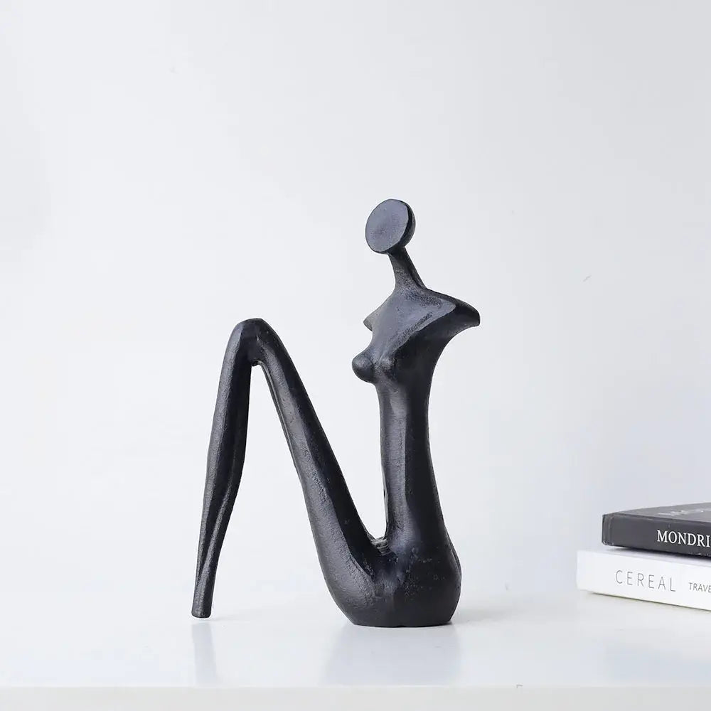 Decorbites abstract black metal female figure sculpture with smooth flowing curves and circular head for home decor